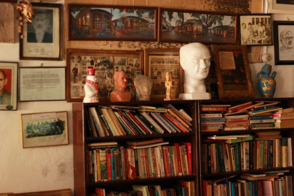 A nostalgic library bookshelf filled with books and historical artifacts.